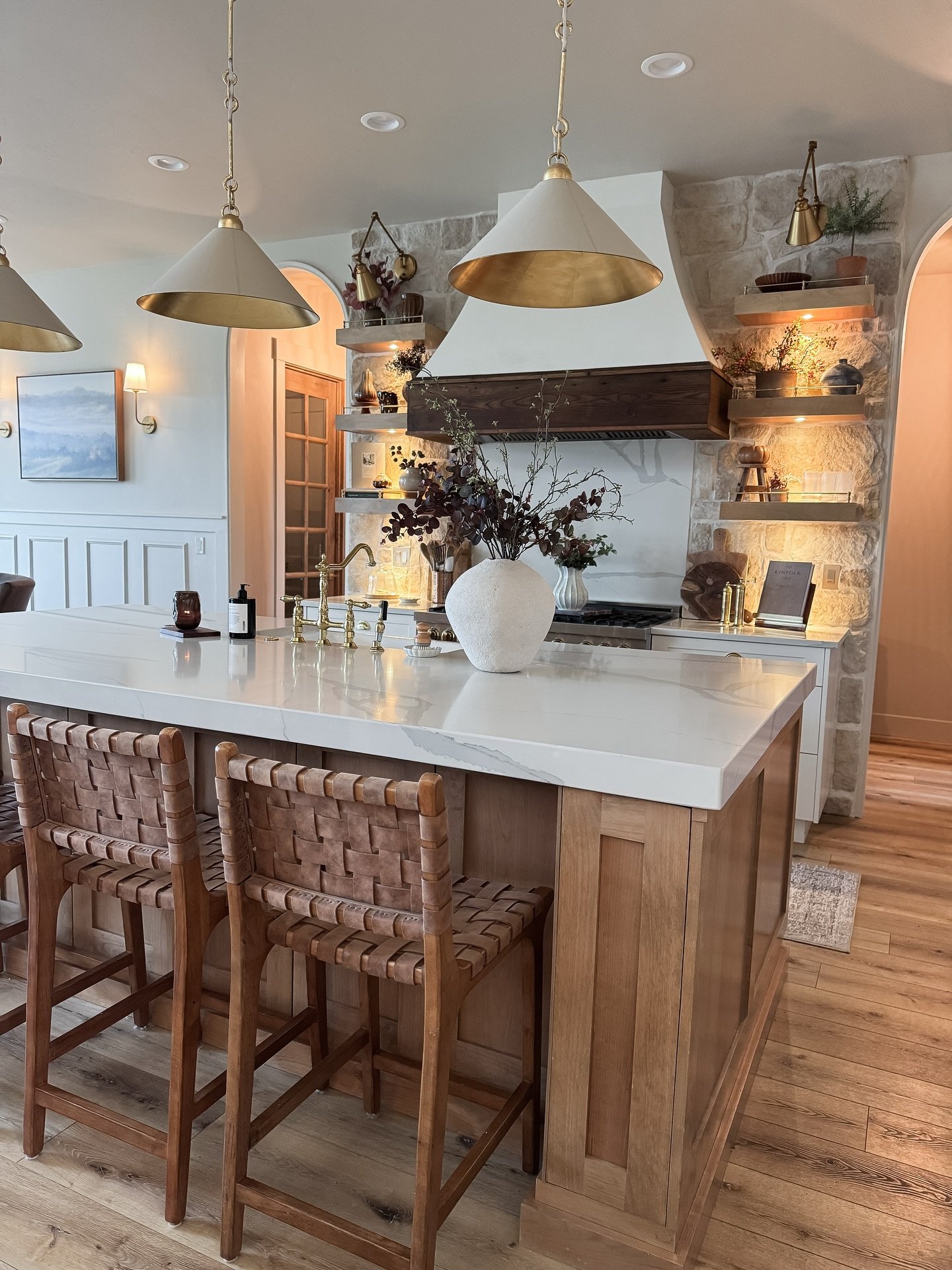 Contemporary pendant with a contrasting metal cap and a matte tapered shade over an island.