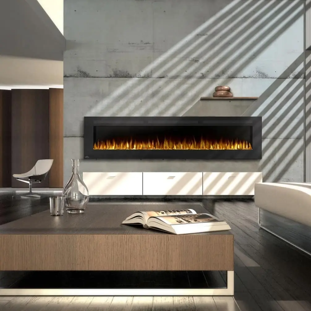 Extra-long, flush-mount black linear electric fireplace set against a raw concrete feature wall, positioned above a low, white floating media cabinet.