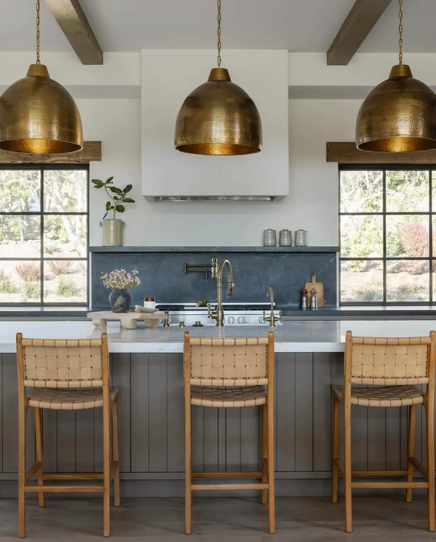 A single, extra-large fabric drum pendant with a diffuser over a large rectangular kitchen island.