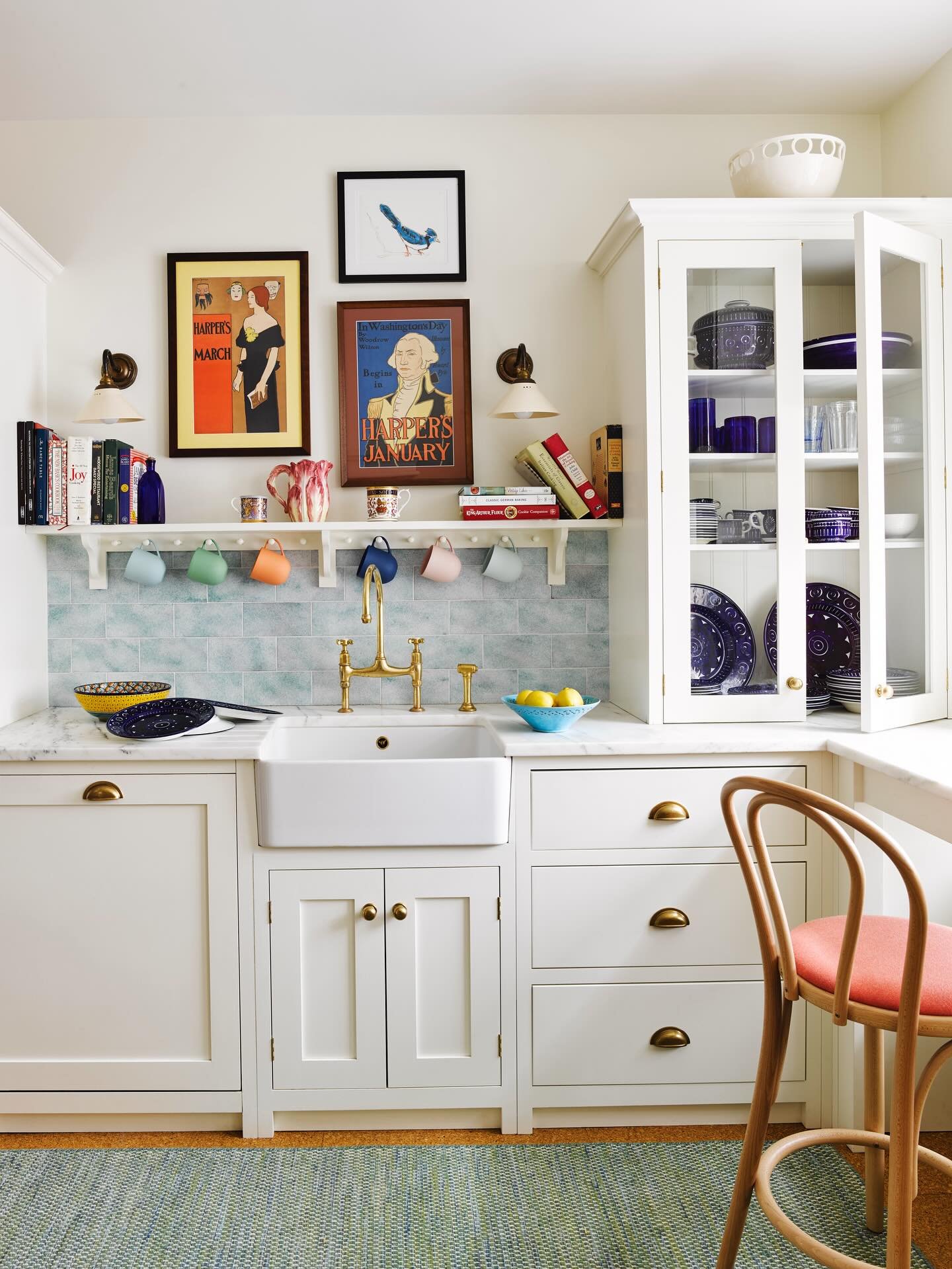A large framed chalkboard on the kitchen wall with hand-drawn art and written messages, next to a marble counter.