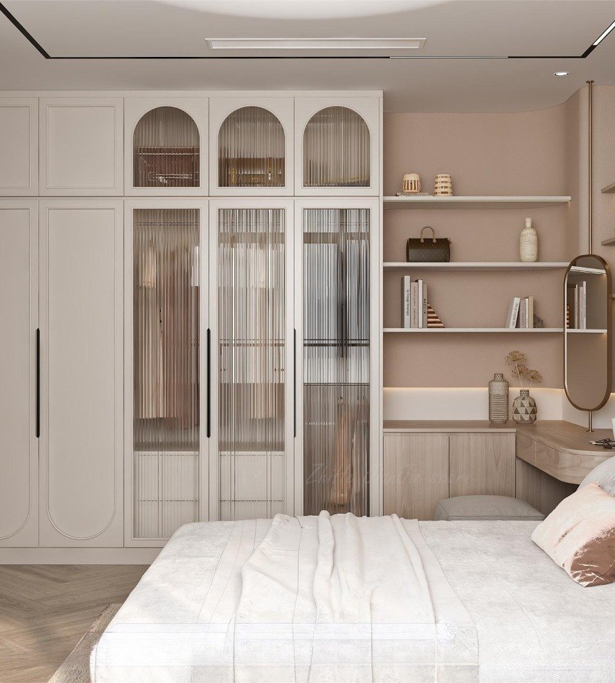 Contemporary floor-to-ceiling white wardrobe featuring a mix of solid doors and central doors with arched tops and vertical reeded glass panels.