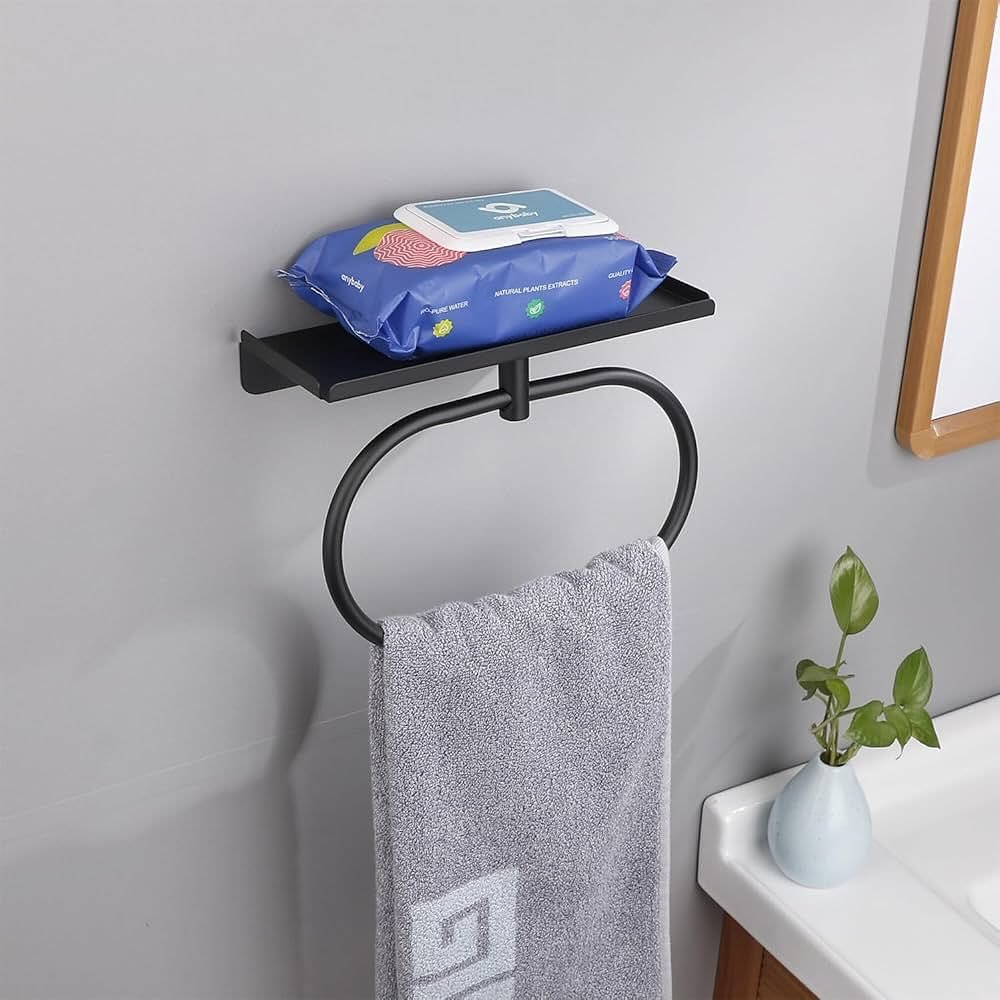 Modern matte black hand towel ring with a small storage shelf on top, holding a gray towel.