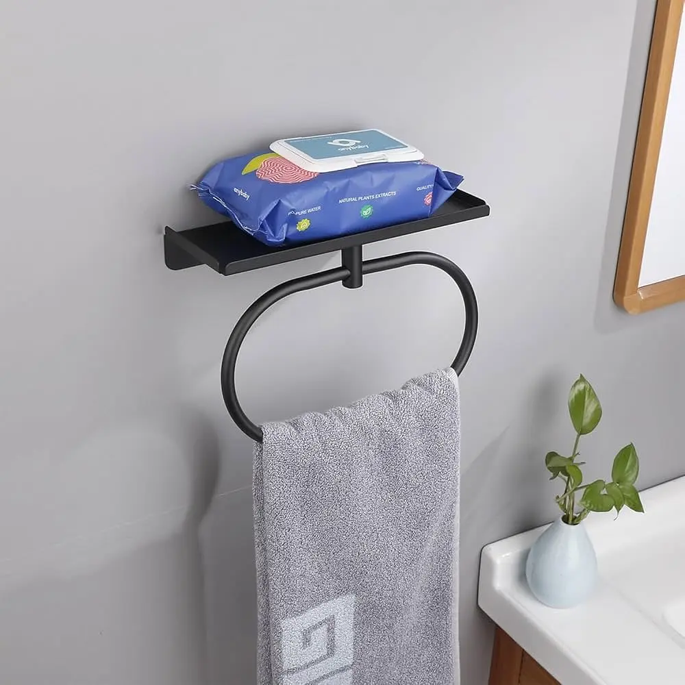 Modern matte black hand towel ring with a small storage shelf on top, holding a gray towel.
