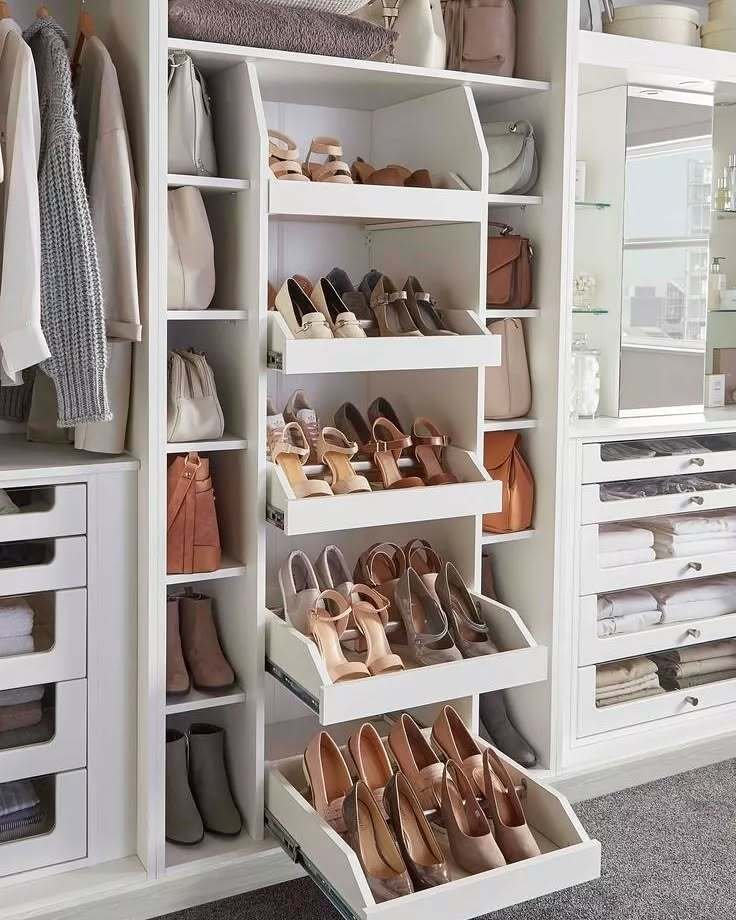 White custom closet system with five tiered, shallow pull-out drawers storing heels and sandals.