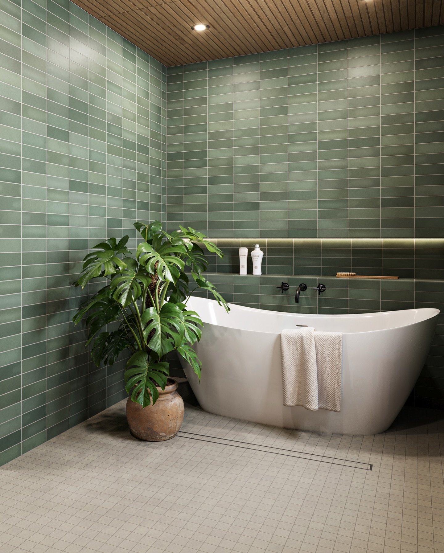 A contemporary bathroom featuring a floor of small, light gray square tiles set in a tight grid pattern, contrasted with green subway wall tiles.