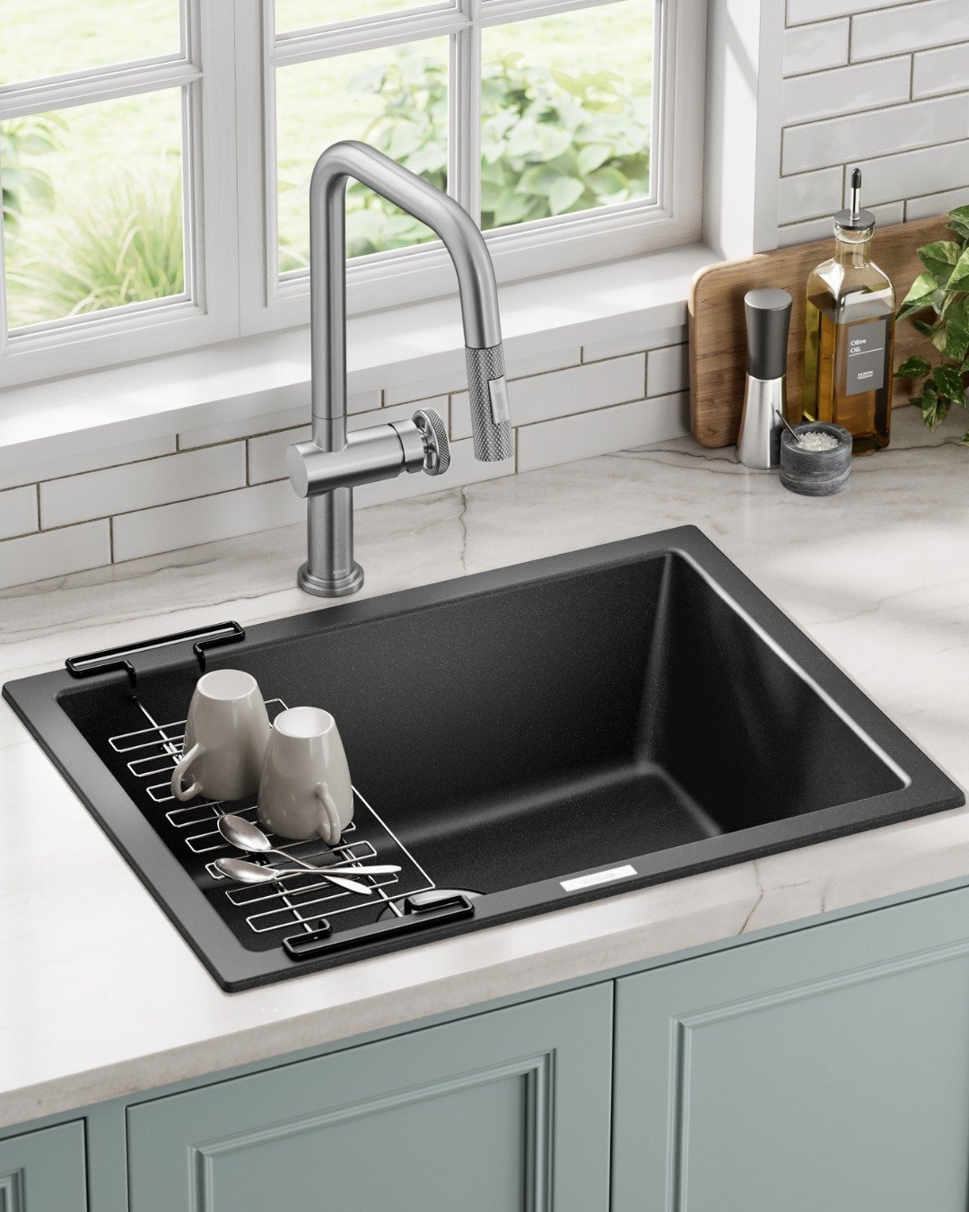 A deep, rectangular single-bowl matte black granite composite sink installed under a white marble countertop with a chrome square-neck faucet.