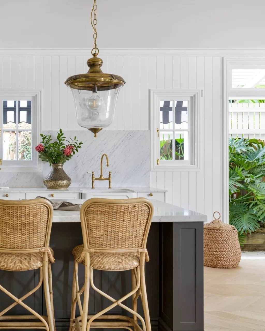 Large, contrasting black bell-shaped pendants hanging over a modern kitchen island.