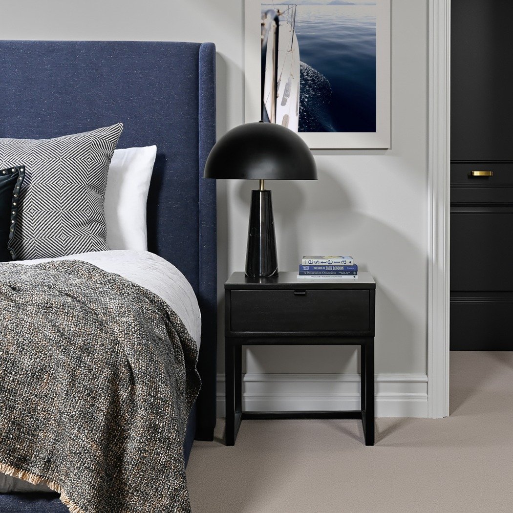 Simple black wood nightstand with one drawer, an open bottom shelf, and a black dome lamp.