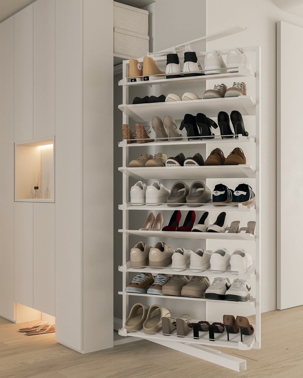 Tall, white metal shoe rack pulled out from a closet, displaying multiple tiers of various shoes.