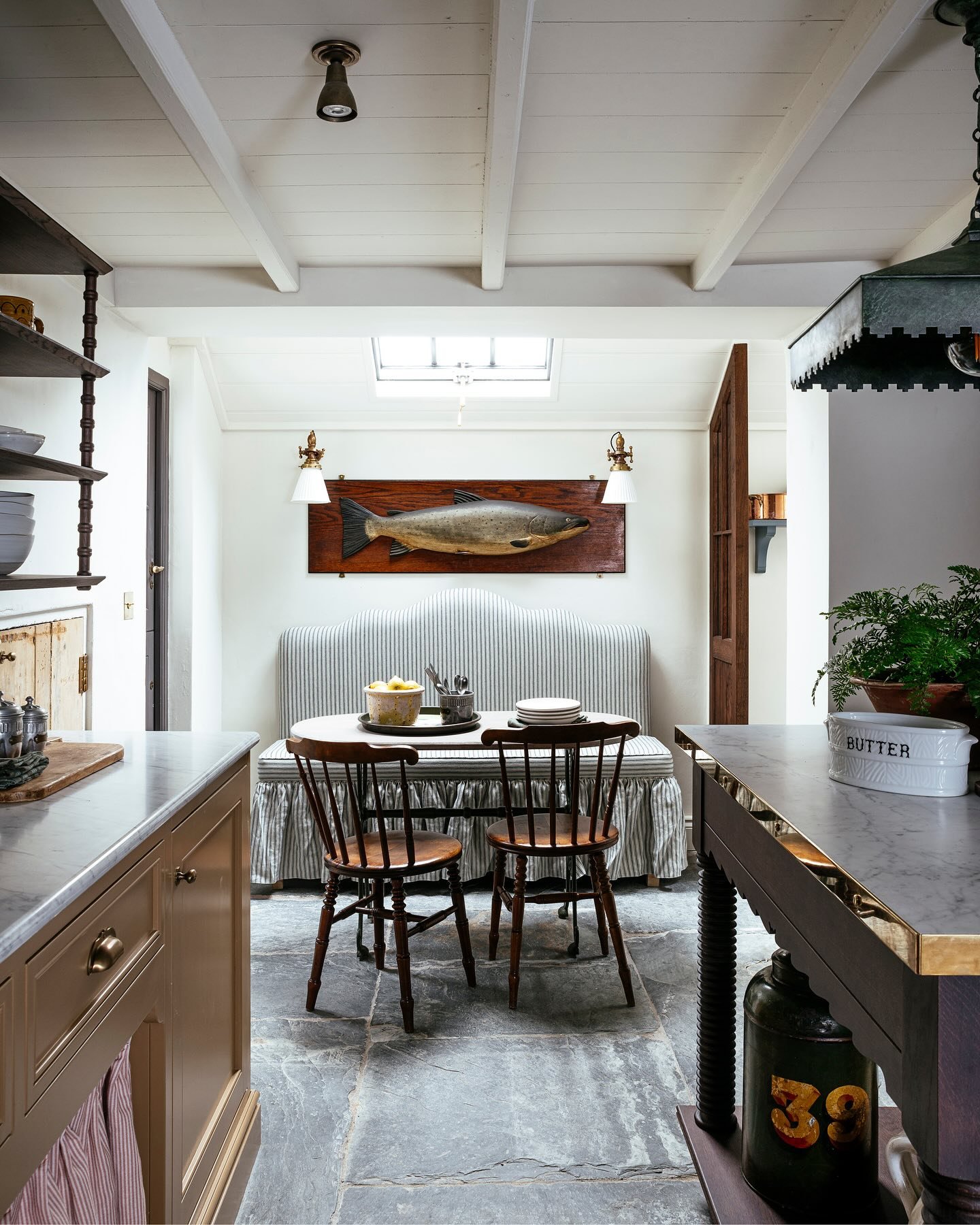Two identical framed black and white prints hanging side-by-side above a kitchen counter with light blue lower cabinets.