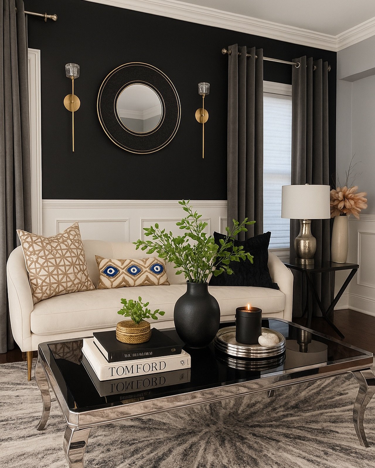Black upper wall with white wainscoting behind a beige sofa and modern decor