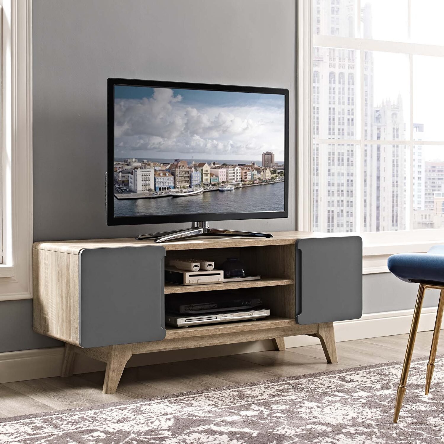 Light wood TV table with dark grey cabinet doors and angled legs