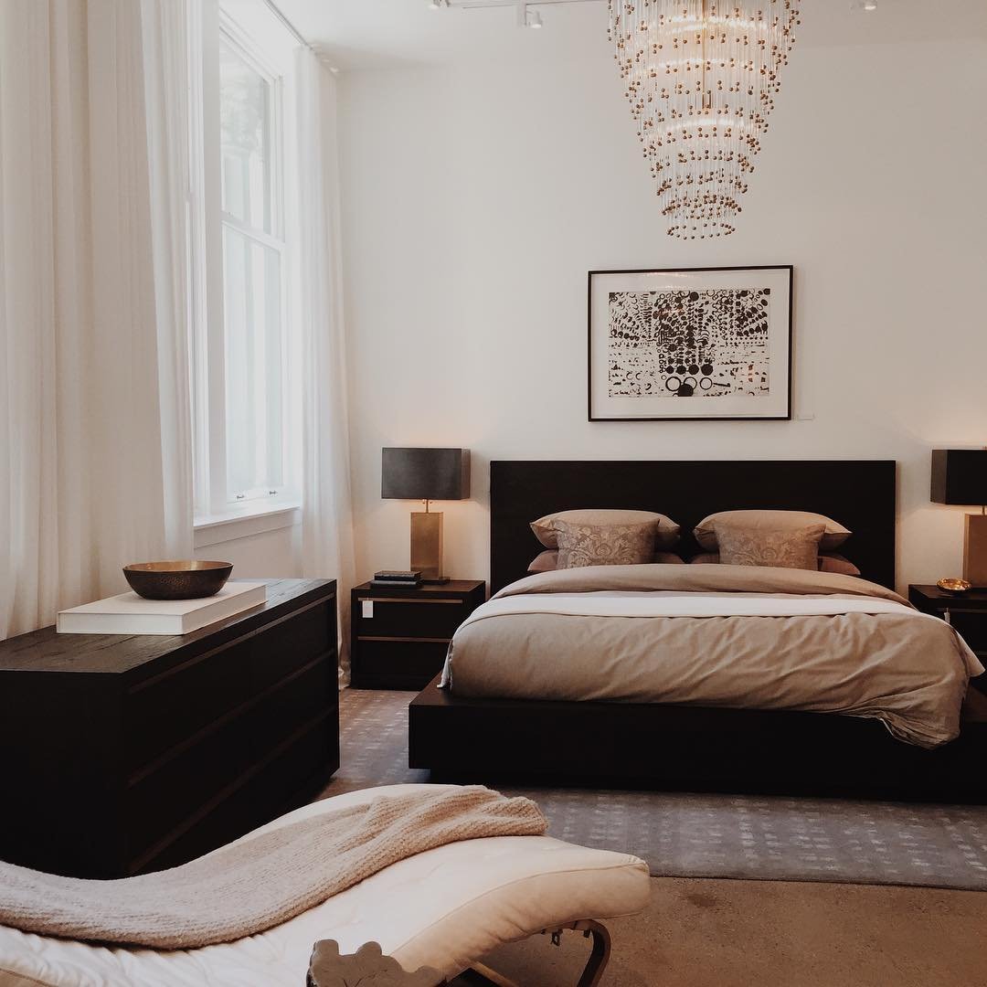 Modern bedroom with crystal chandelier and black furniture