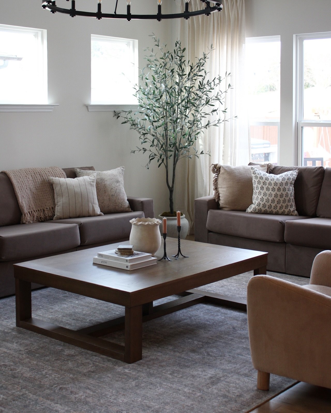 Large square dark wood coffee table with sled base in a cozy living room