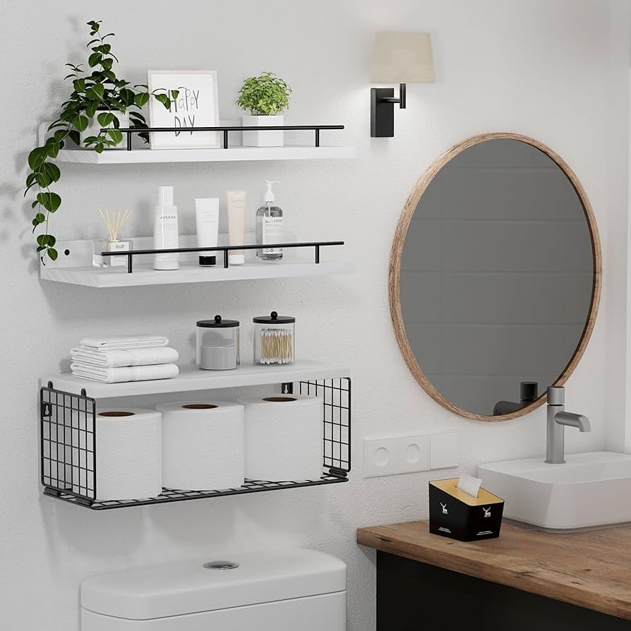 White shelves with black guard rails and a wire storage basket hanging above a toilet