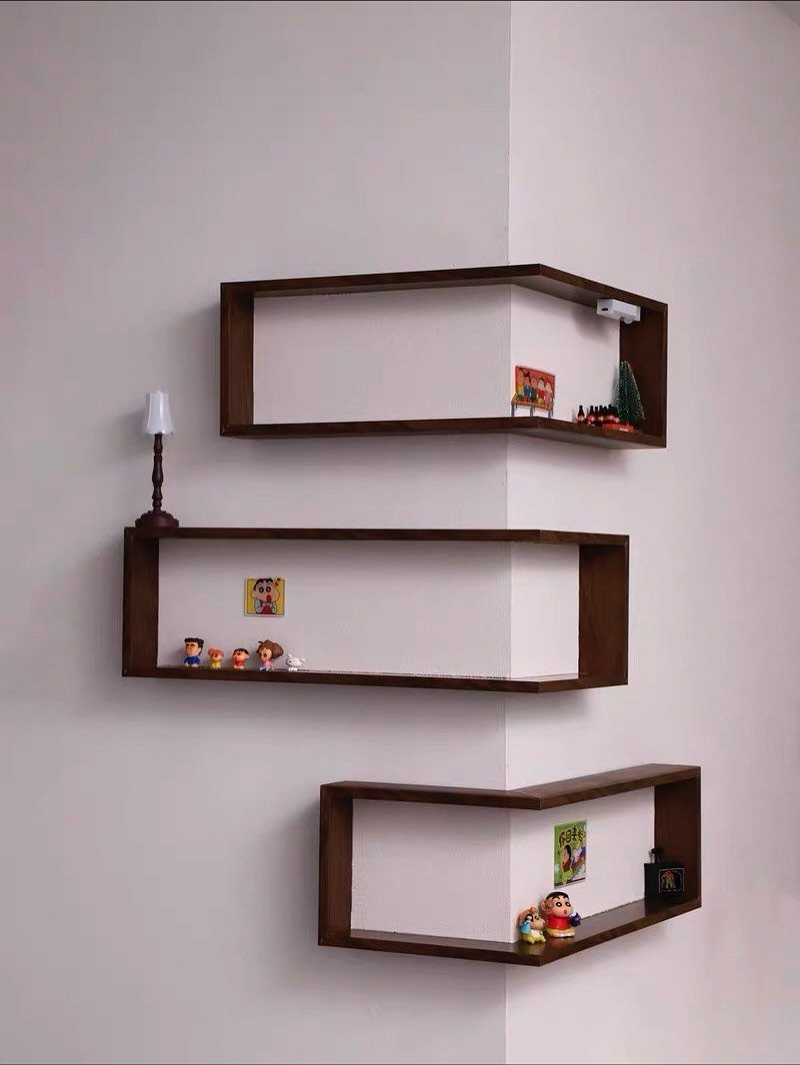 Three dark wood rectangular box shelves wrapping around an outer white wall corner in a staggered pattern.
