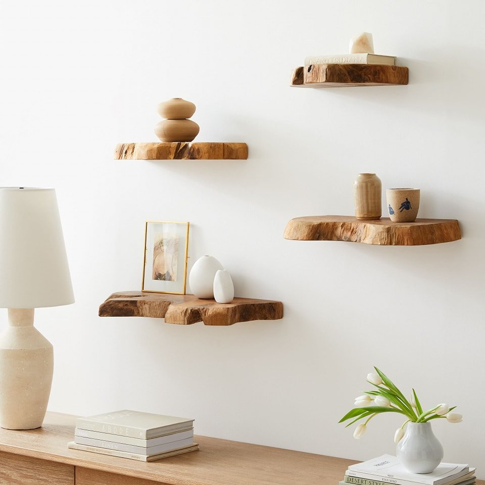 Rustic log slice floating shelves displaying small ceramics