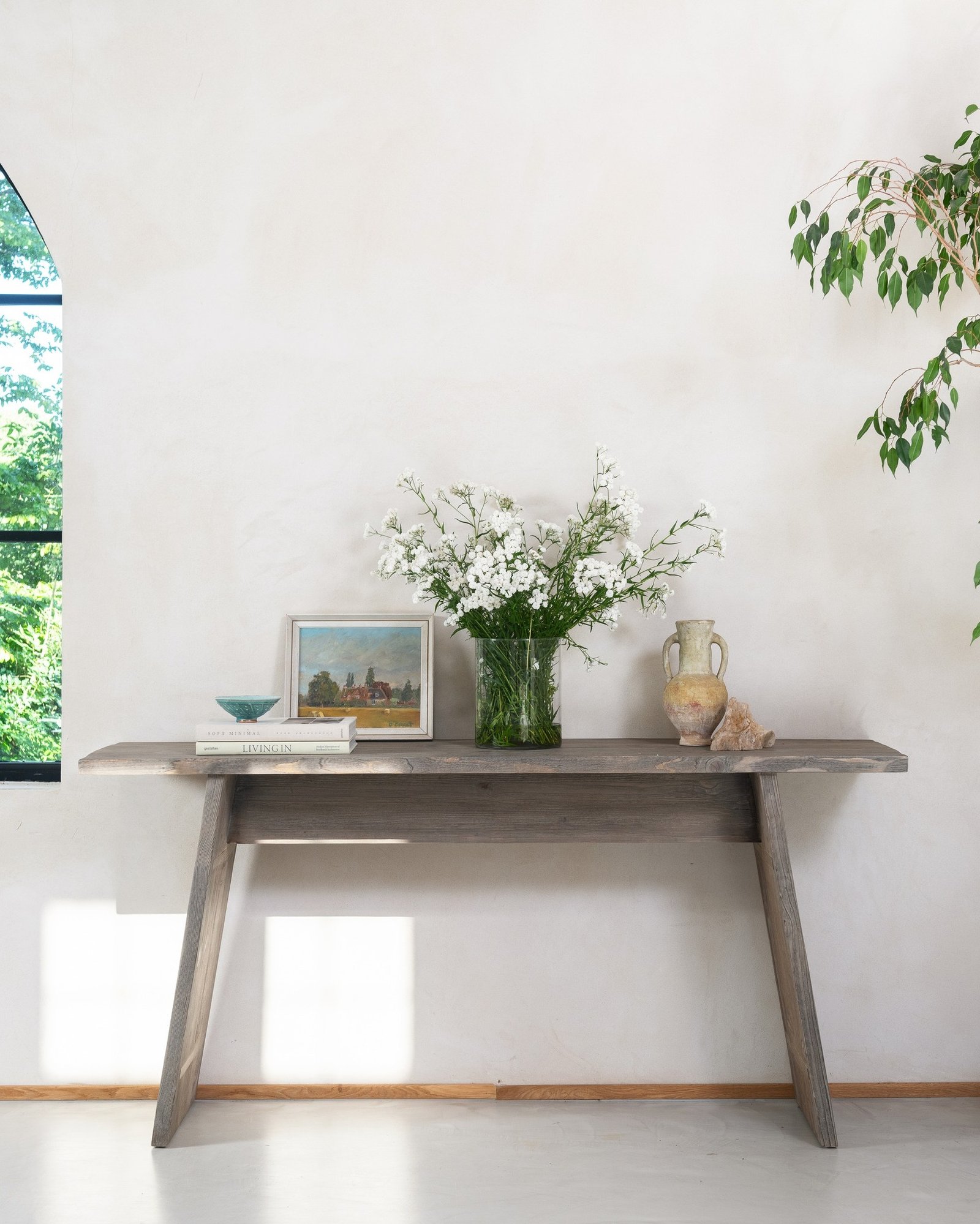 Angled wooden hallway table with fresh white flowers