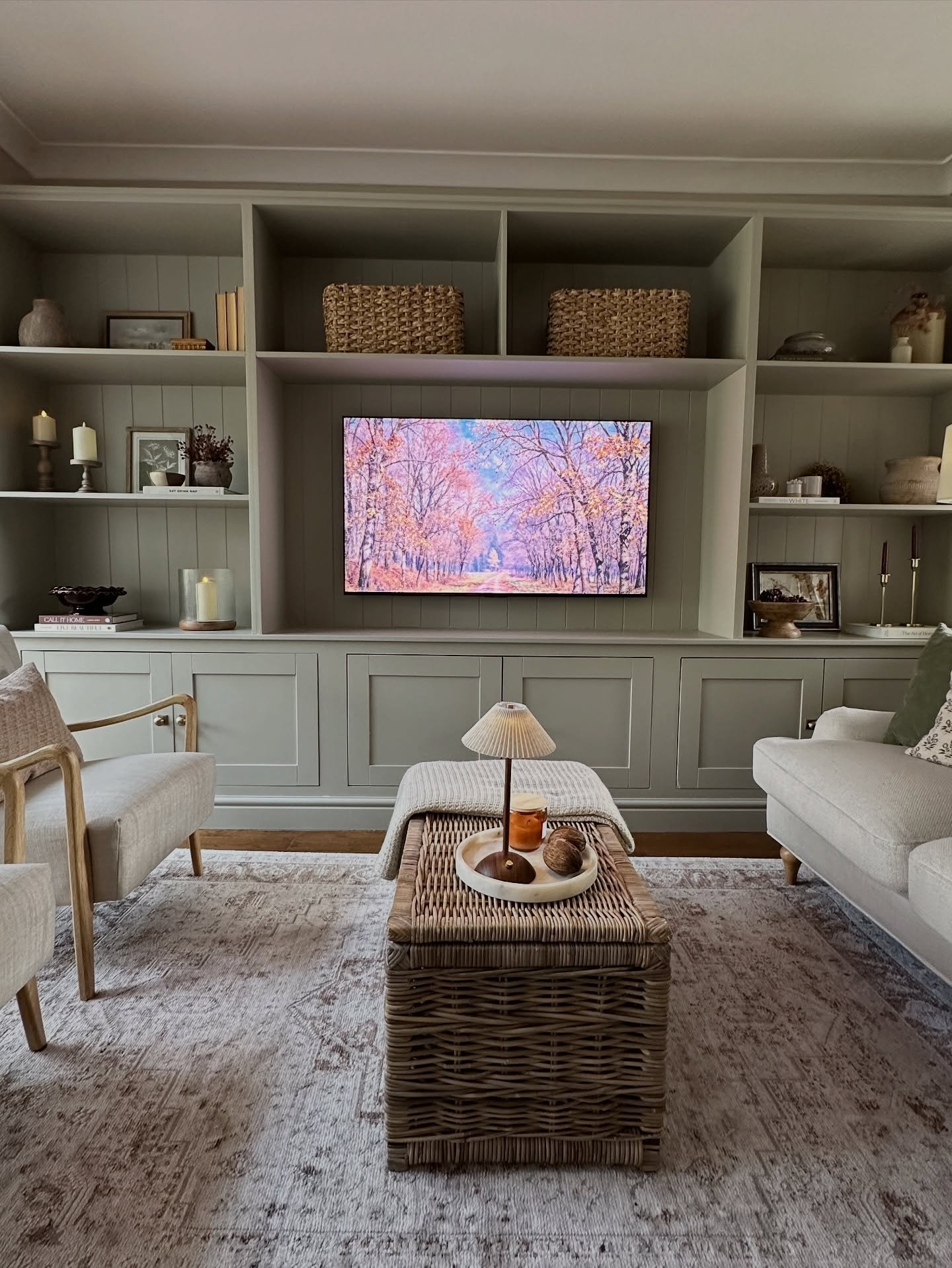 Greige built-in media wall with shiplap backing and woven baskets above a TV