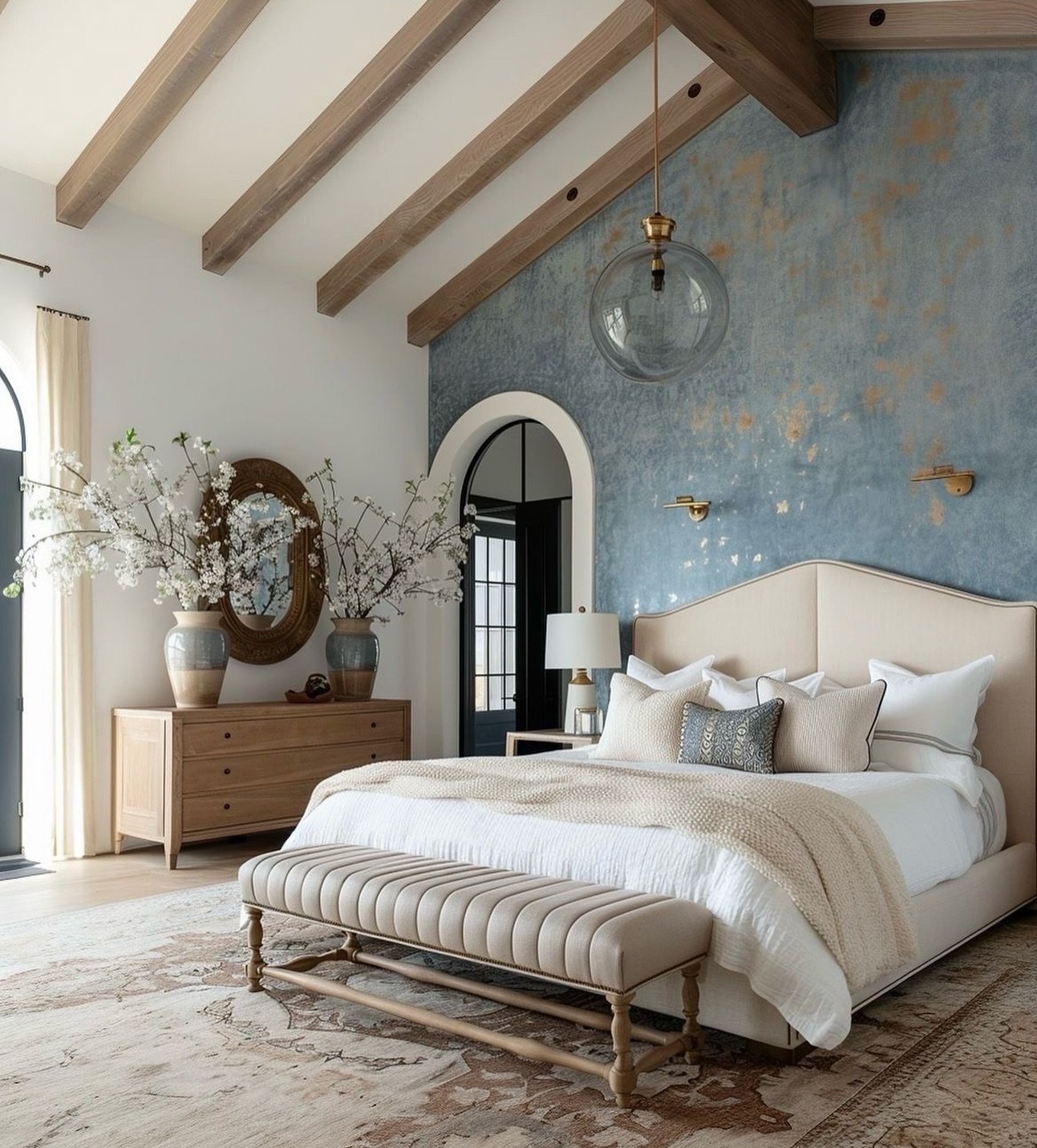 Close-up view of a textured blue bedroom accent wall with metallic gold gilded splatters.