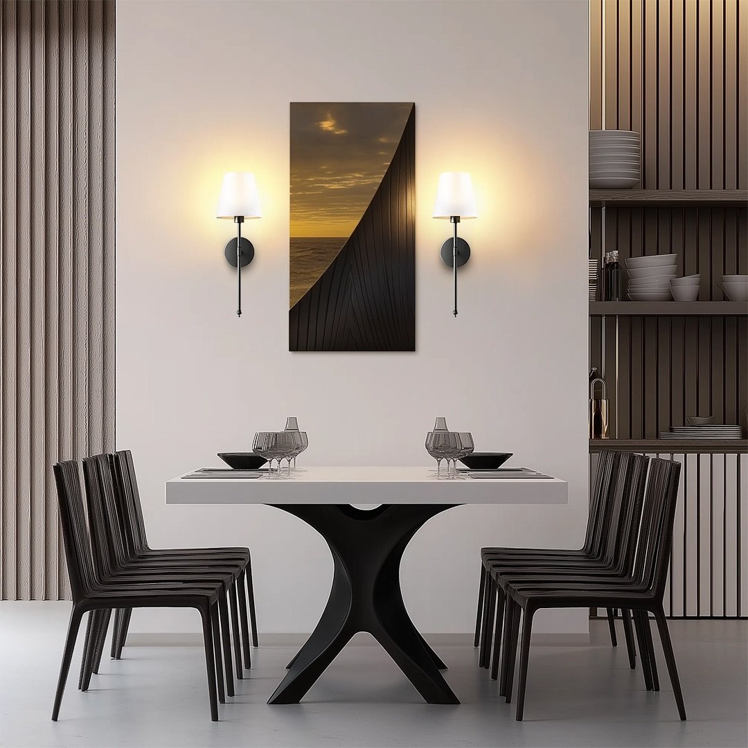Modern dining room wall featuring central sunset artwork flanked by matching wall sconces