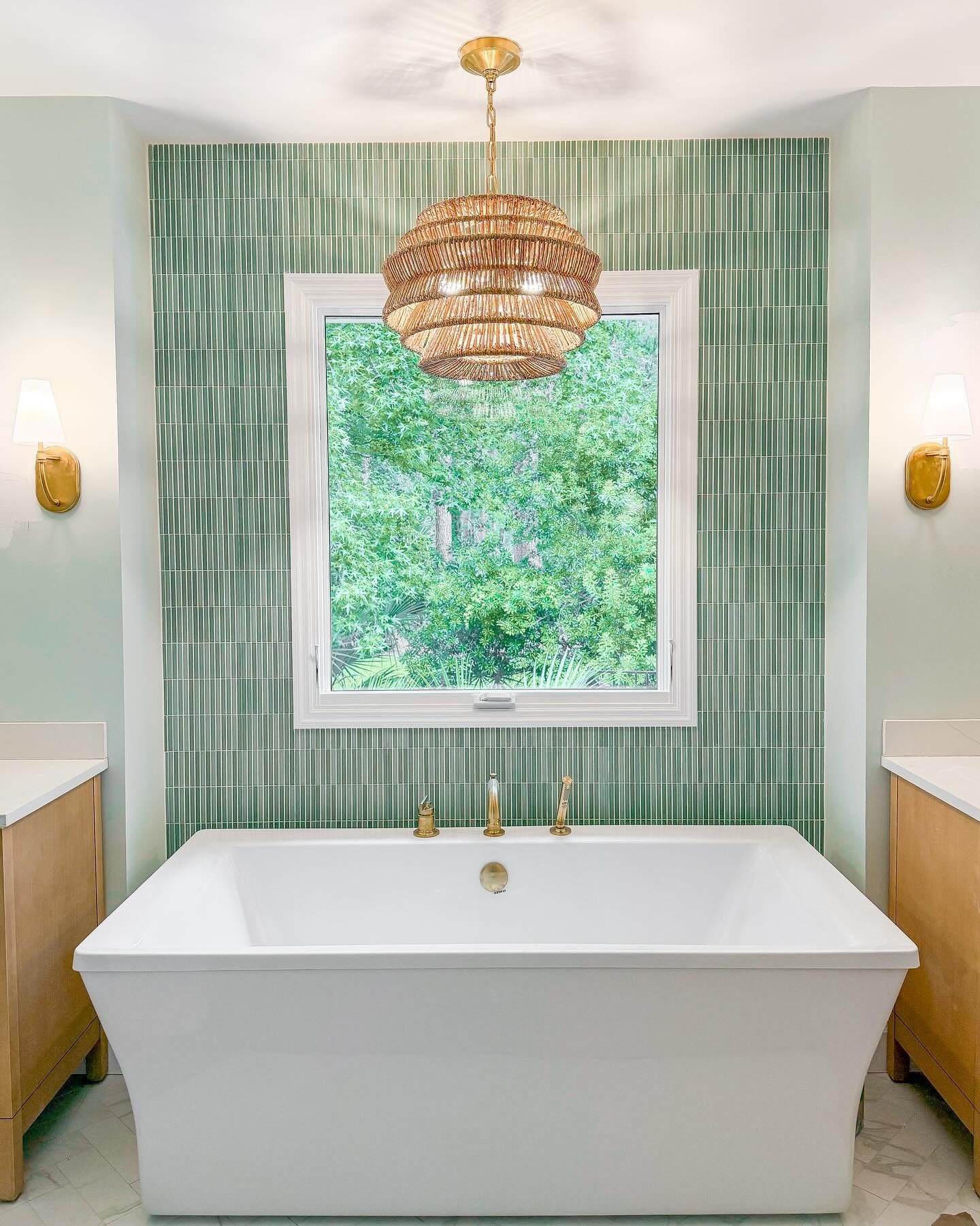 Vertical green kit kat tile accent wall behind a white bathtub.
