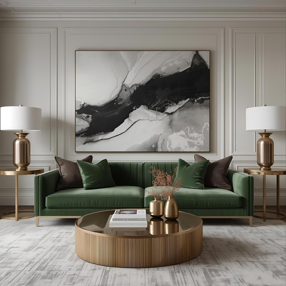 White paneled living room wall featuring a large black and white abstract painting above a green velvet sofa.