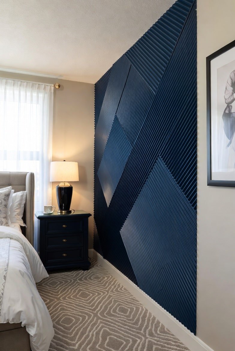 Navy blue 3D accent wall with diagonal ridged panels arranged in a geometric pattern