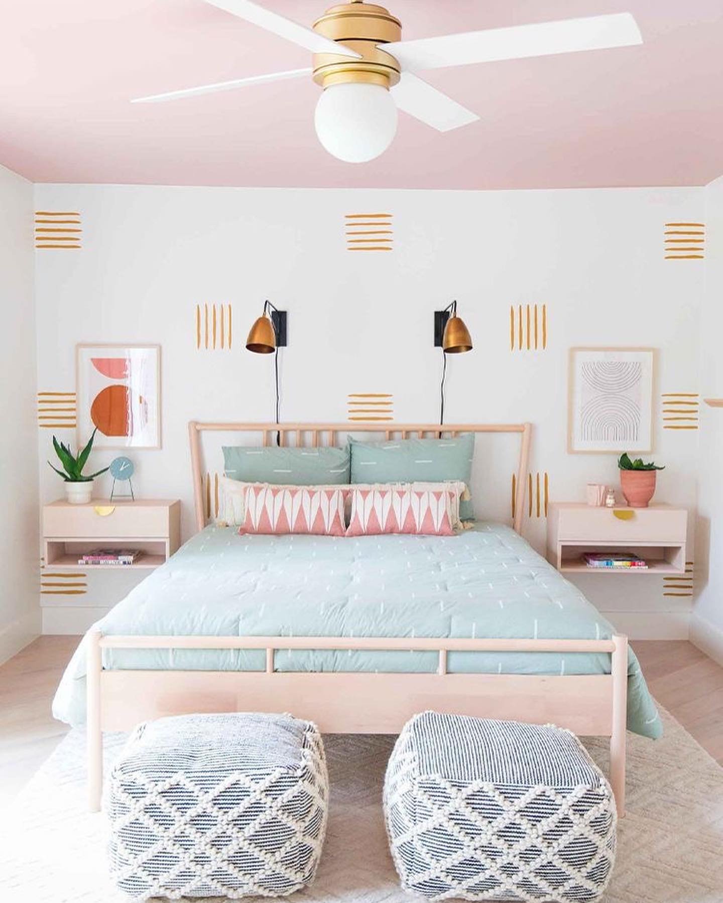 White bedroom accent wall featuring gold painted hash marks and a pink ceiling