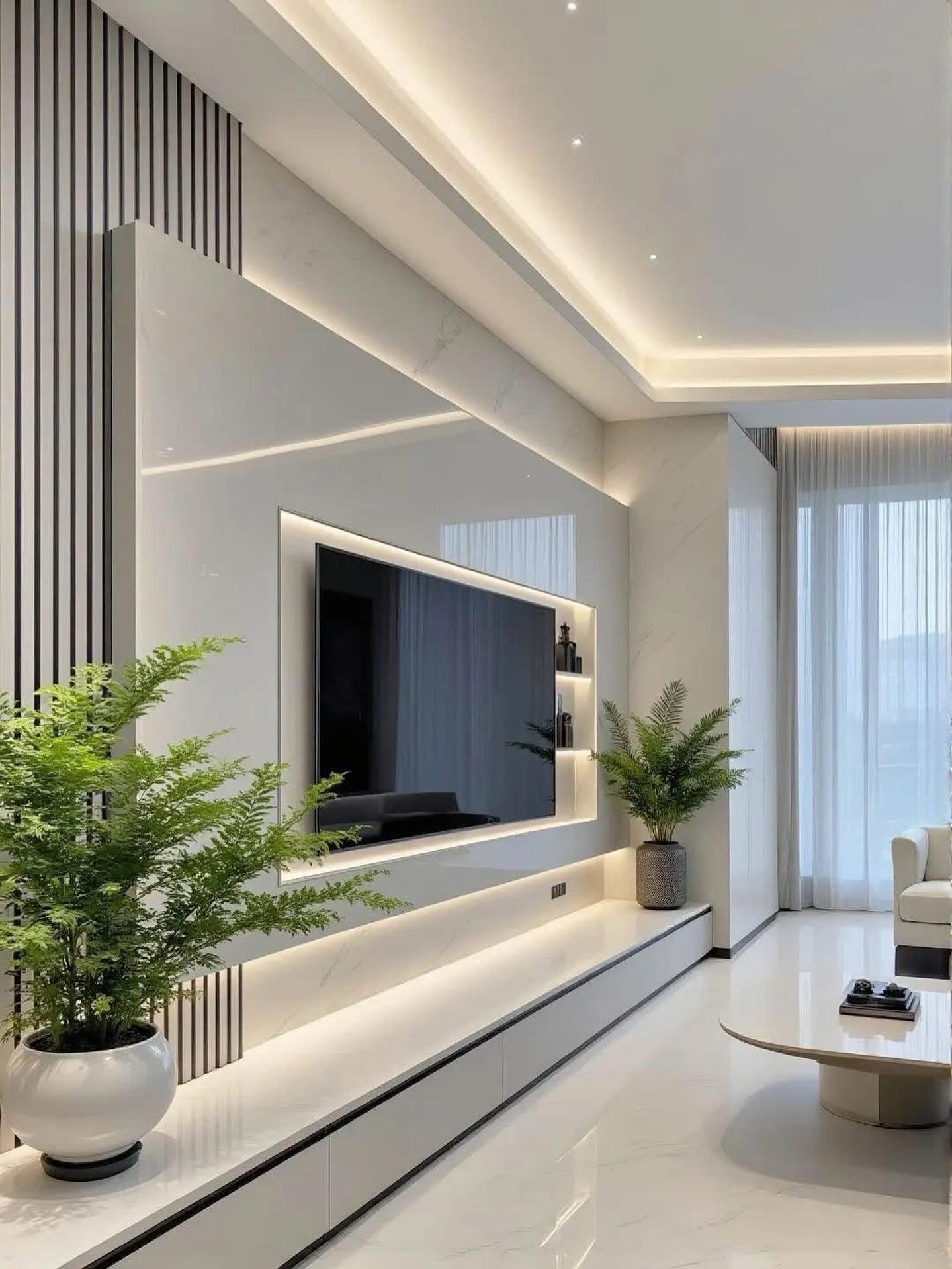 Glossy white layered TV wall with LED lighting and vertical strip details.