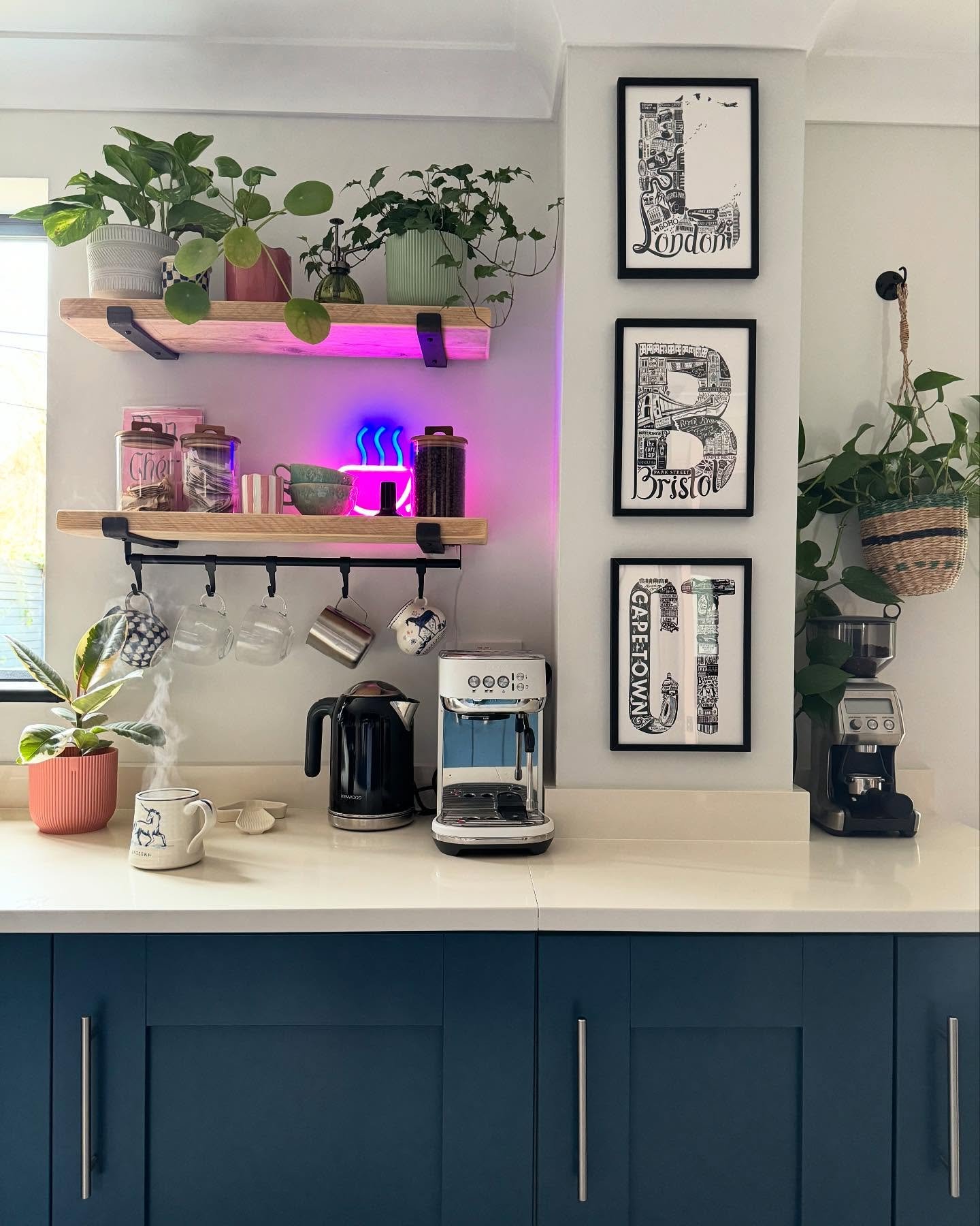 Kitchen pillar featuring three framed black and white city typography prints
