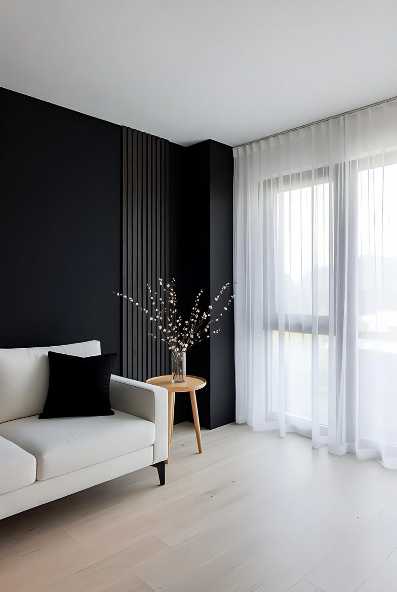 Vertical slatted black accent wall in a living room corner with a white sofa and sheer curtains.