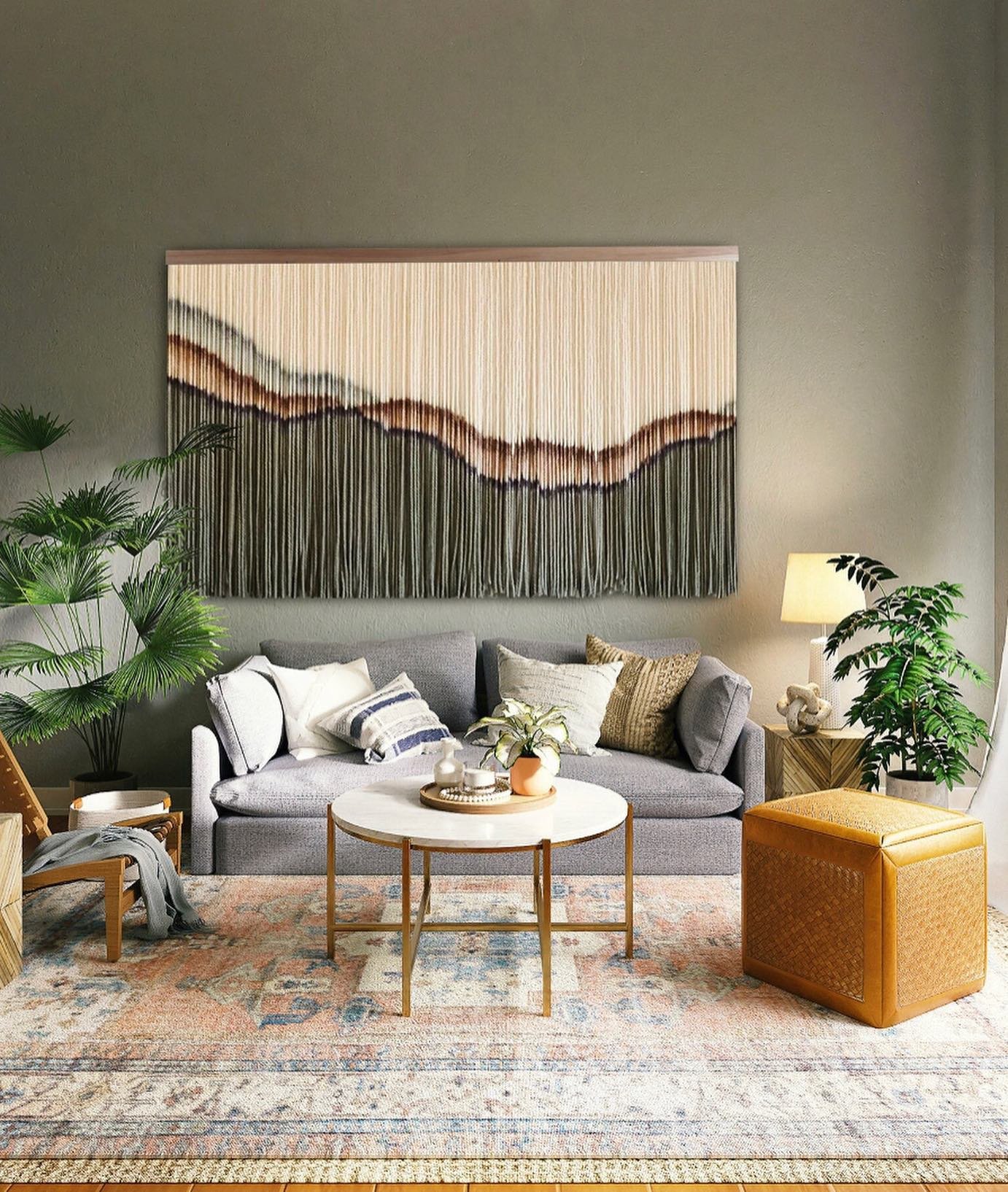 Grey living room wall featuring a massive horizontal dip-dyed macramé hanging above a sofa.