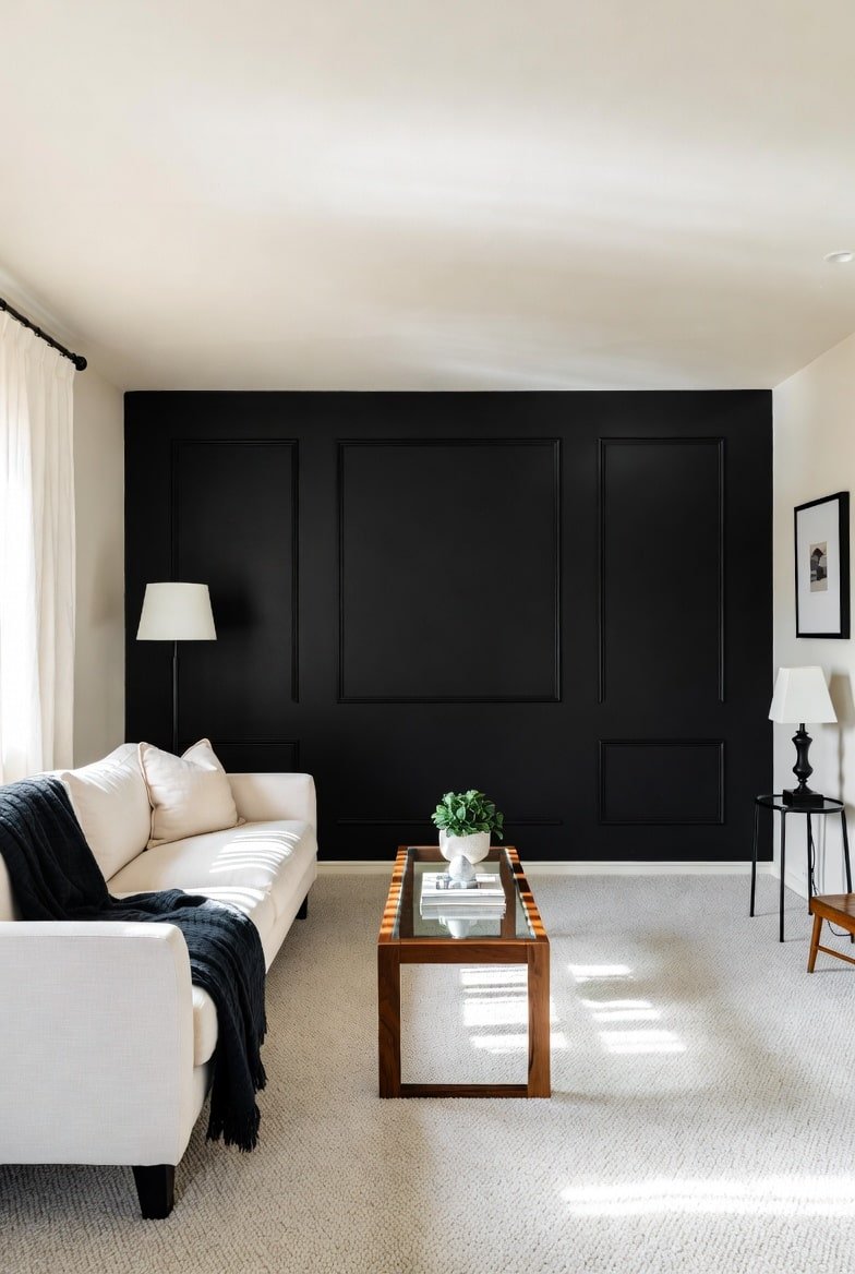 Living room featuring a flat matte Black Accent Wall behind a mounted TV and media console with two white wall sconces.