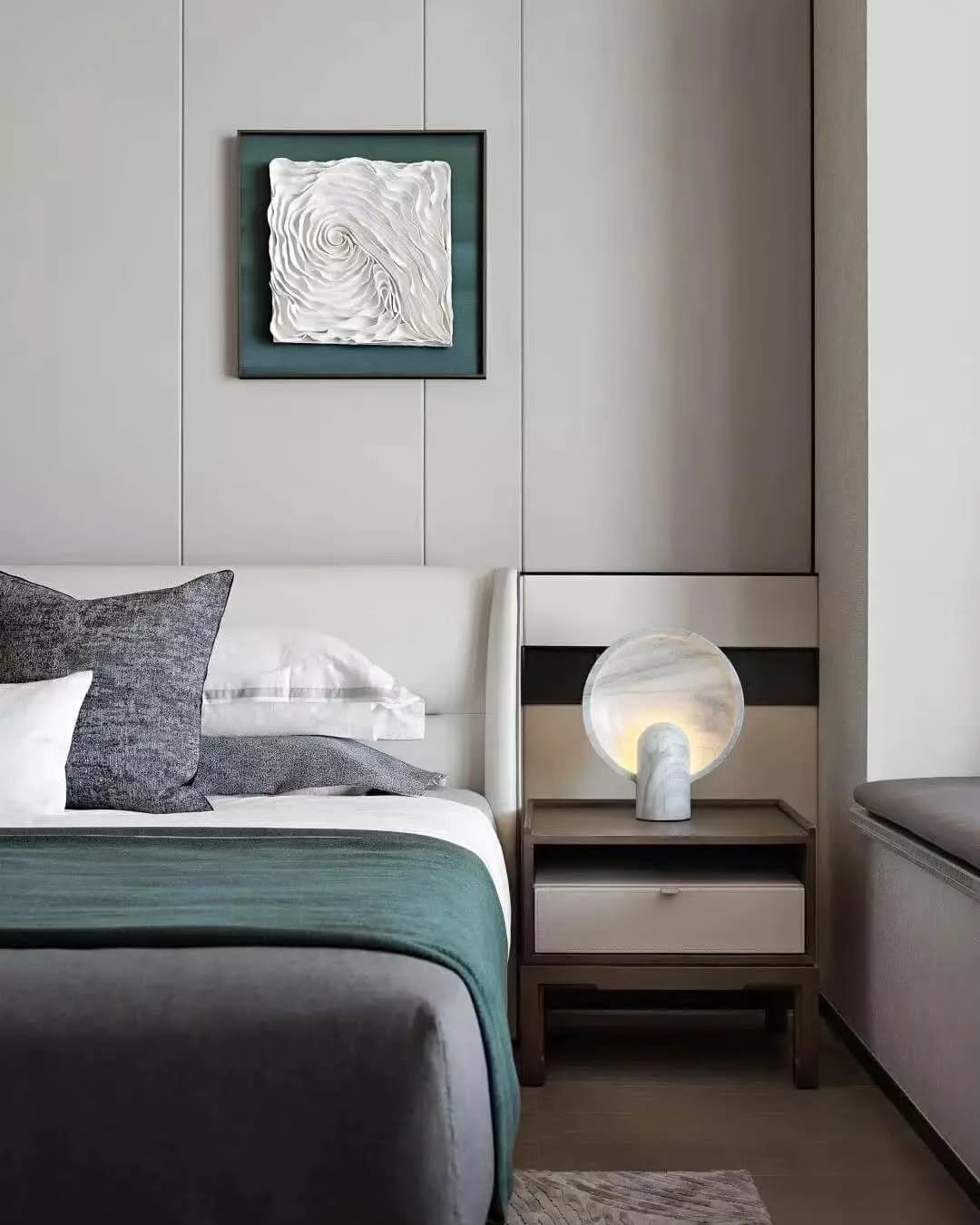 Gray vertical wall paneling featuring a framed white 3D swirl art piece