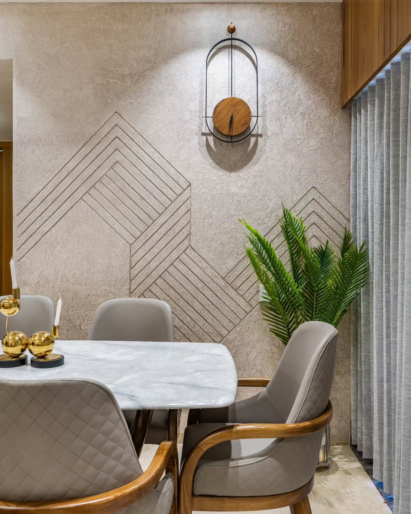 Textured dining accent wall featuring carved geometric lines and minimalist clock