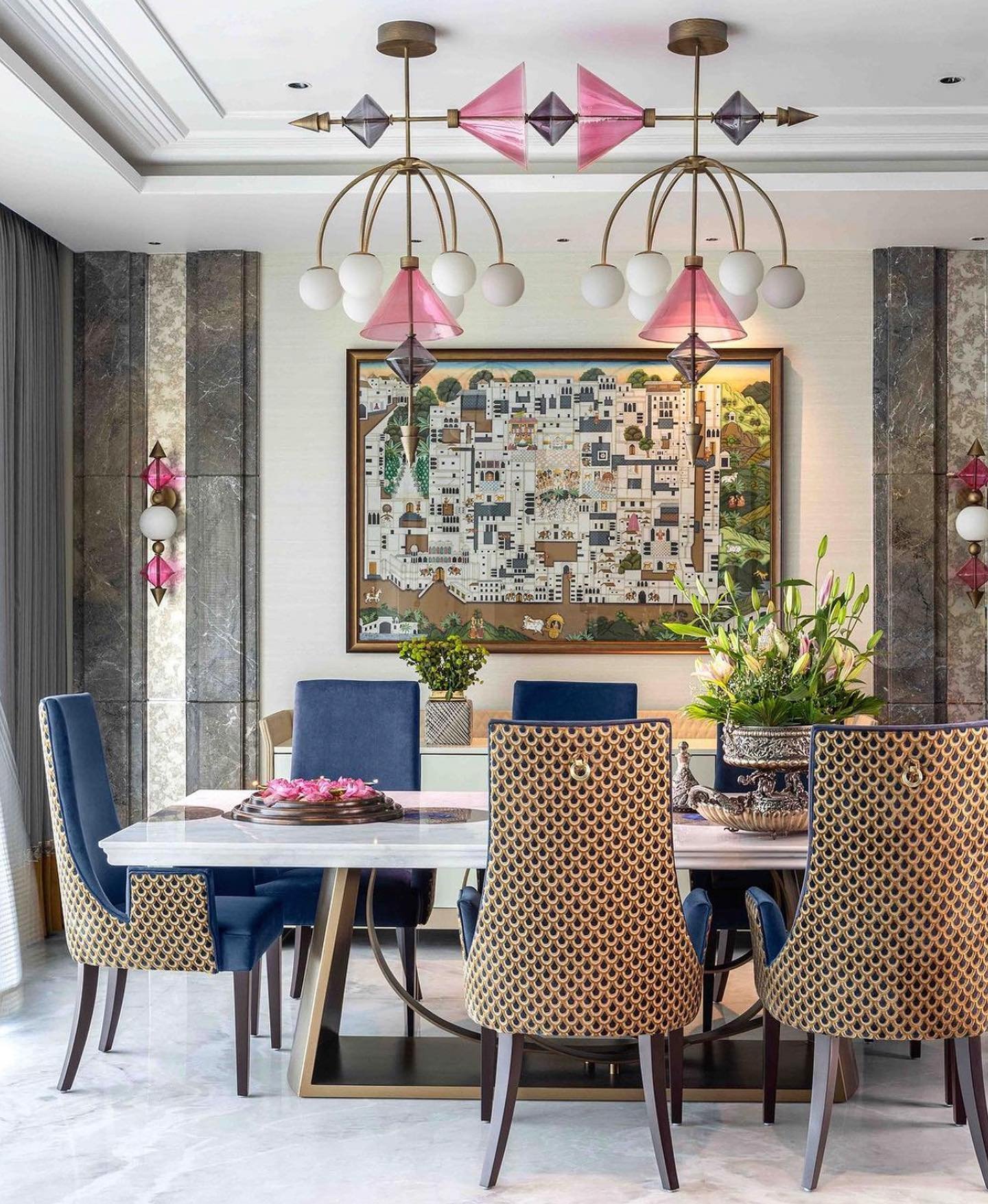 Luxurious dining room wall featuring large cityscape art flanked by grey marble columns