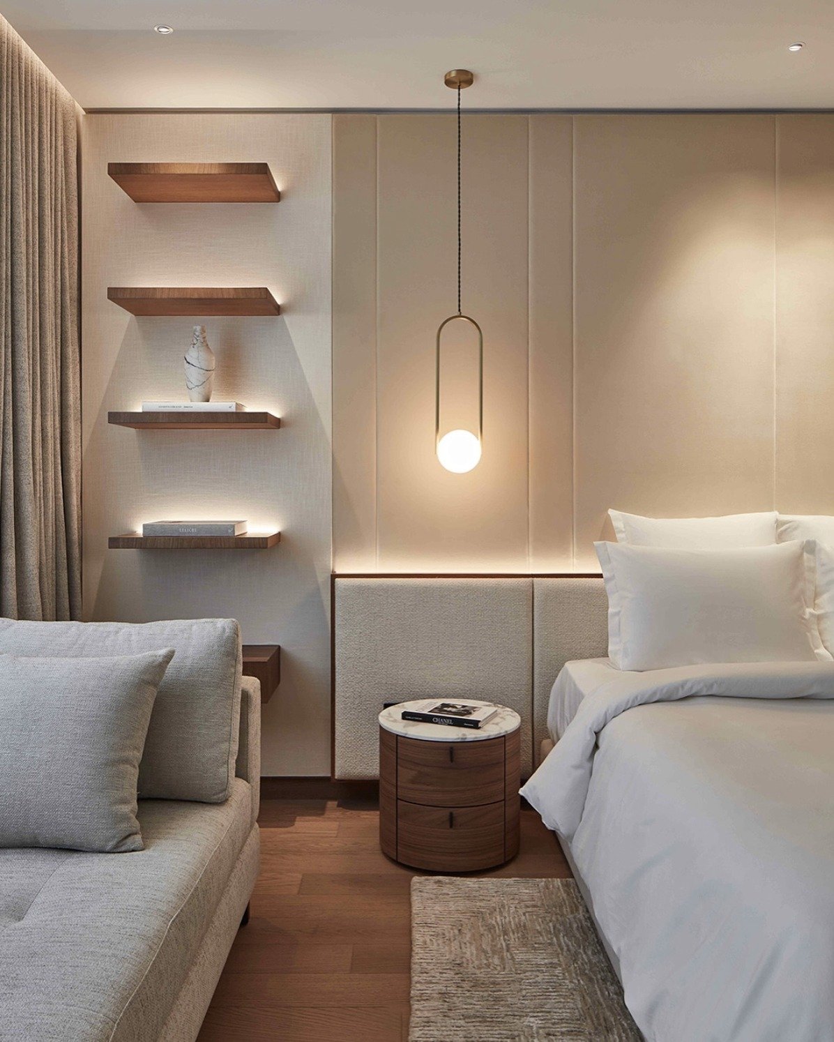Beige bedroom accent wall featuring vertical paneling with headboard backlighting and illuminated floating wood shelves.