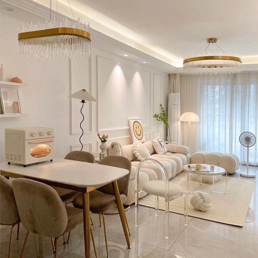 Bright living room featuring white wainscoting on the accent wall illuminated by recessed ceiling lights and a unique wavy floor lamp.