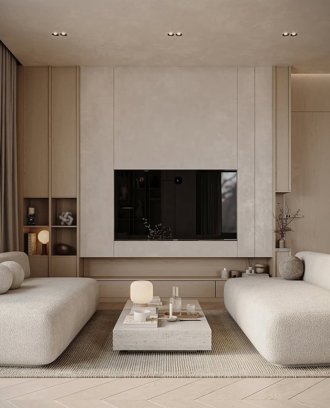 Beige textured TV wall with built-in wooden cabinets and curved sofas.