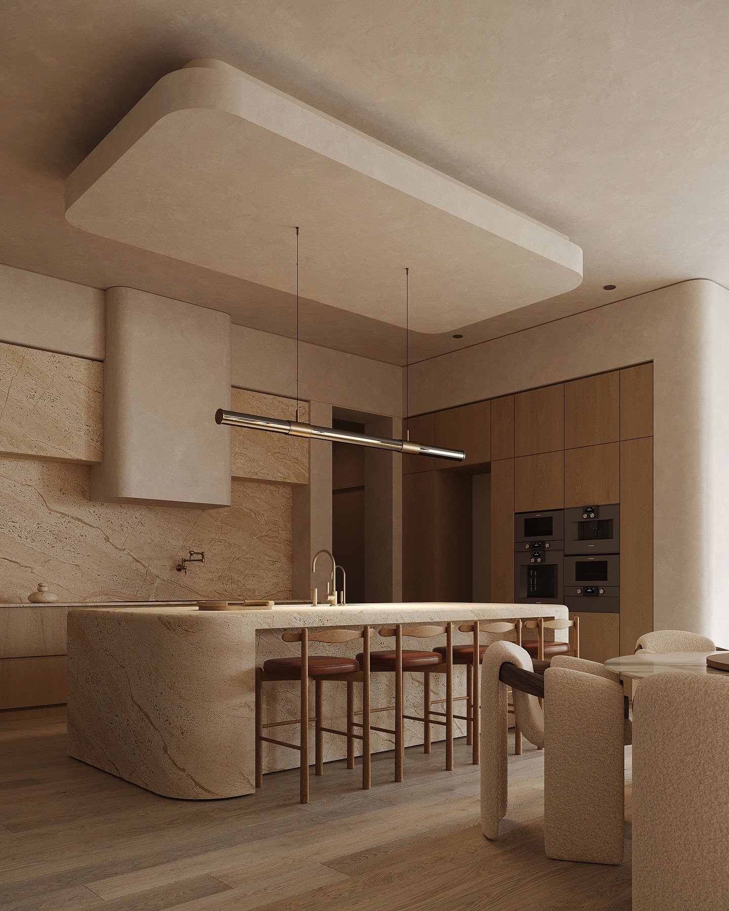 Horizontal dark metallic tube light hanging over a rounded beige stone kitchen island.