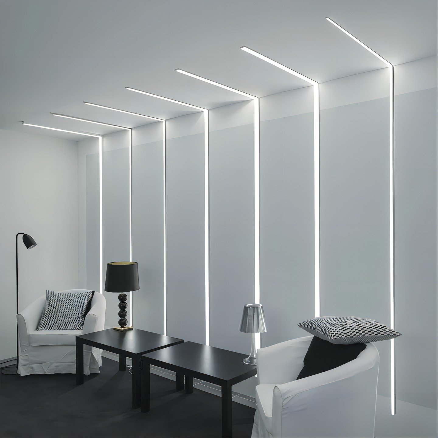Minimalist living area featuring vertical LED strips running up the white wall and continuing across the ceiling.