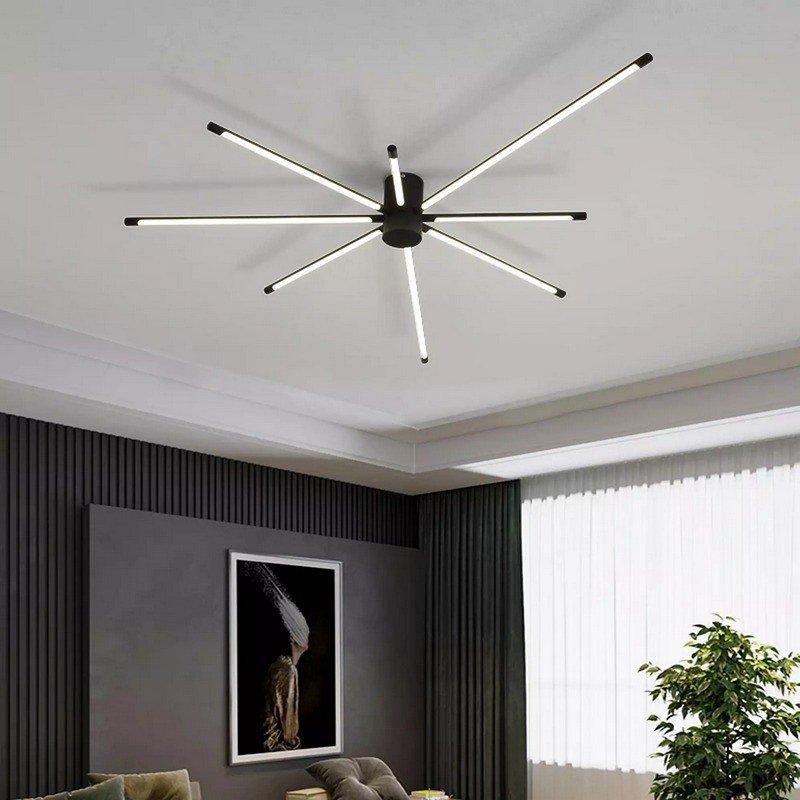 Bedroom ceiling with a modern black sputnik-style LED chandelier and dark grey fluted wall paneling.