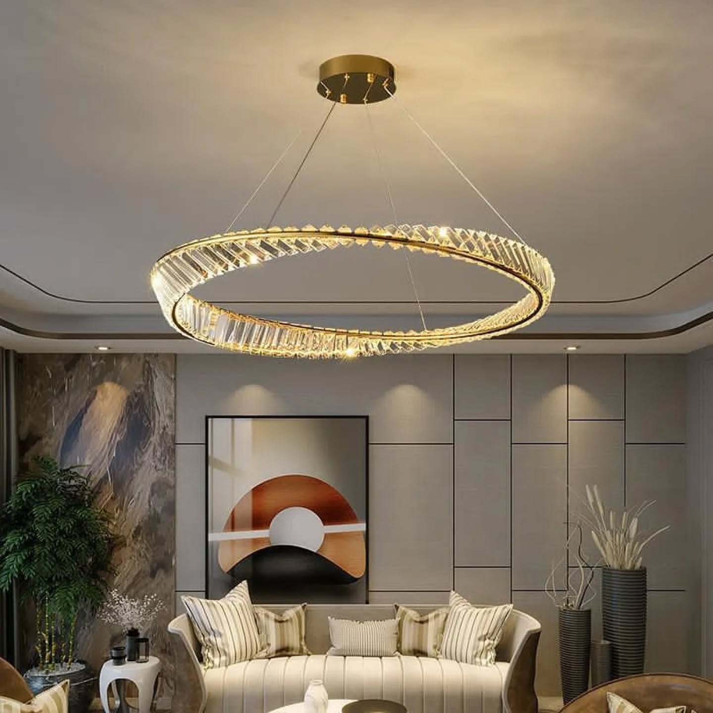 Modern living room featuring a single gold ring chandelier with crystals hanging above a gray paneled wall.