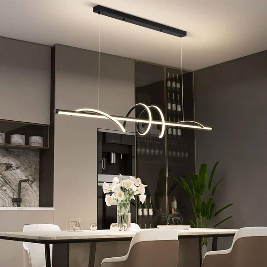 Black linear light with curved LED loops hanging over a white kitchen table.