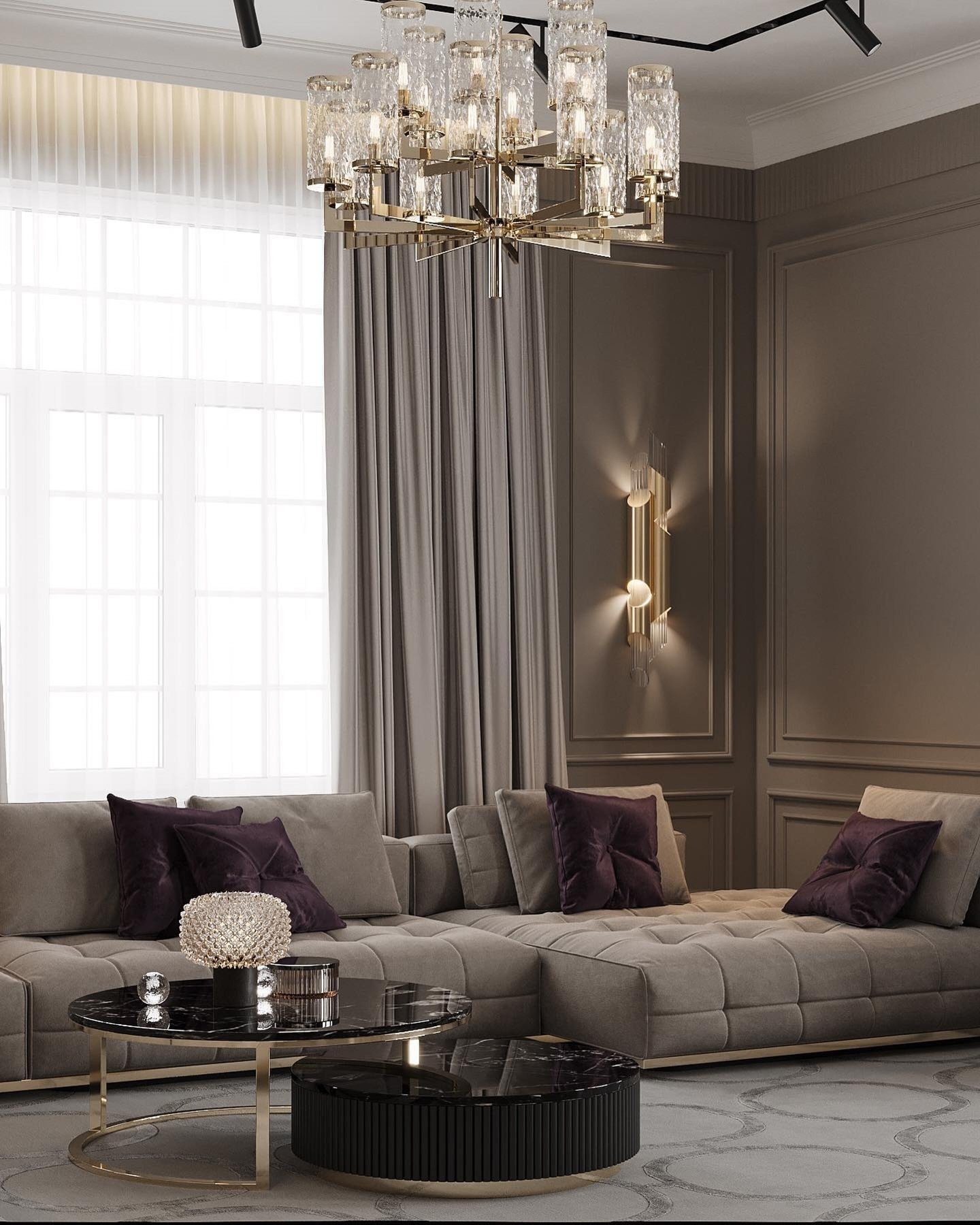 Luxurious living room featuring a gold and textured glass chandelier above a tufted taupe sectional.