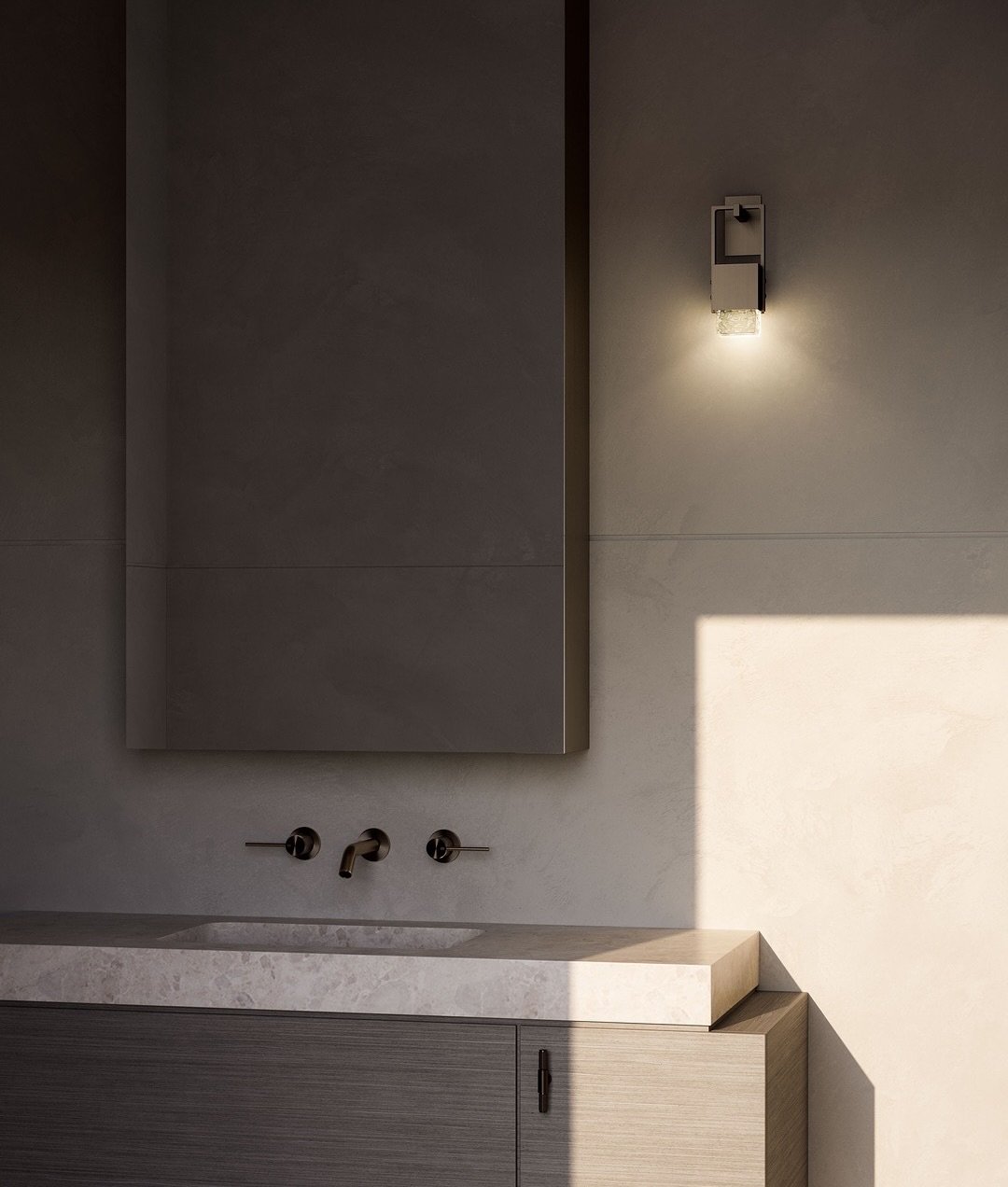 Minimalist bathroom with textured plaster wall featuring small geometric sconce and rectangular mirror