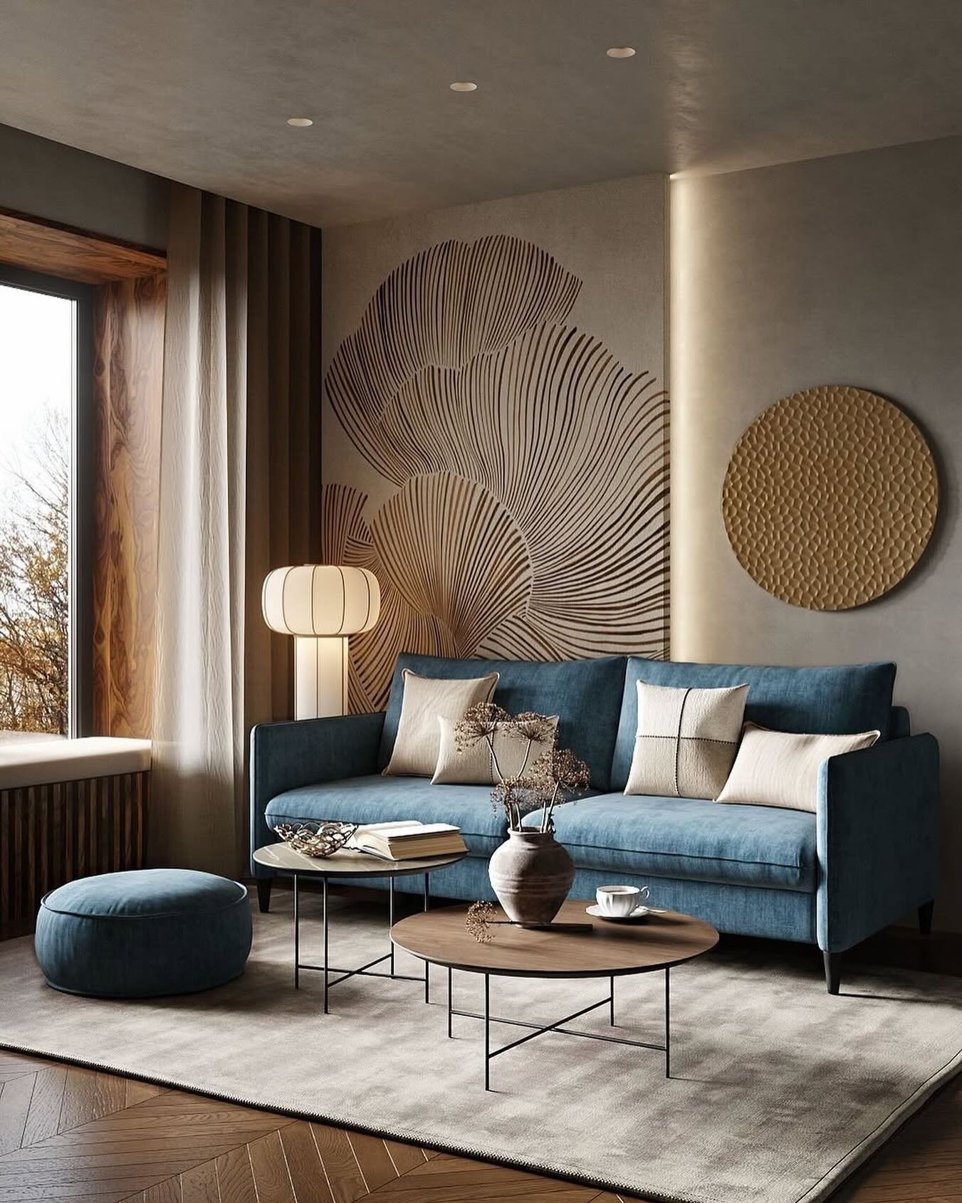 Beige living room wall featuring large botanical line art and a textured gold circular wall hanging.