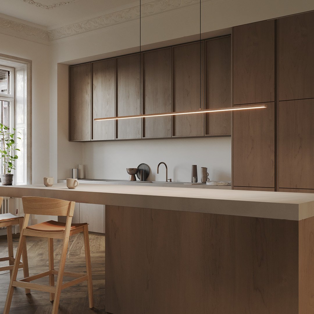 Razor-thin horizontal light bar hanging over a large wooden kitchen island.