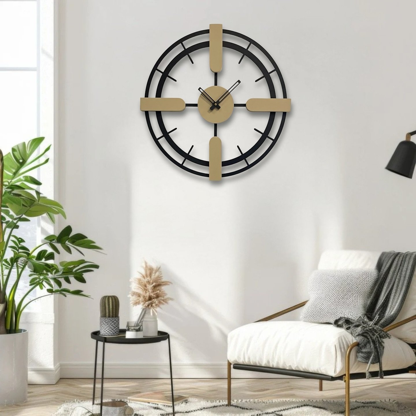 Modern black and gold geometric wall clock mounted on a white wall above a white armchair